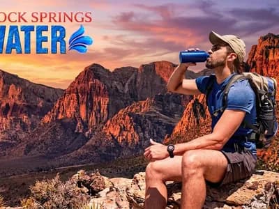 Hiker drinking water at Red Rock Canyon outside Las Vegas in summer heat, Red Rock Springs Water hydration guide
